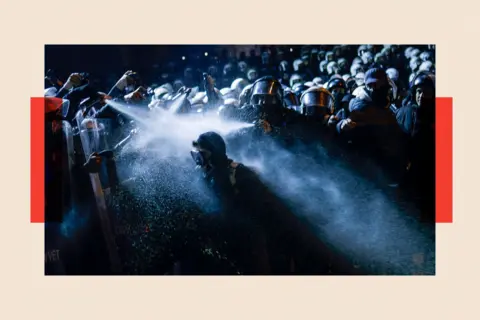 KEMAL ASLAN/AFP via Getty Images Turkish riot police spray tear gas onto a protester during a demonstration outside Istanbul's city hall to support Istanbul mayor Ekrem Imamoglu