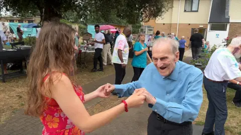 Care home resident dancing and smiling