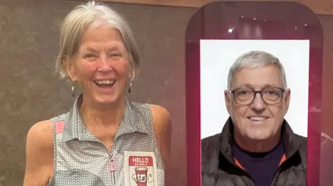 George Johnsen Pam stands smiling broadly next to the hologram version of Bill which is a picture of him smiling on a large screen