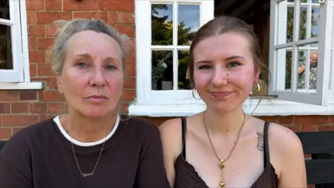 Two women sitting together in a pub garden