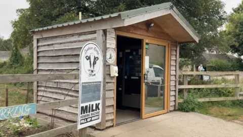  A brown shed with glass windows. 