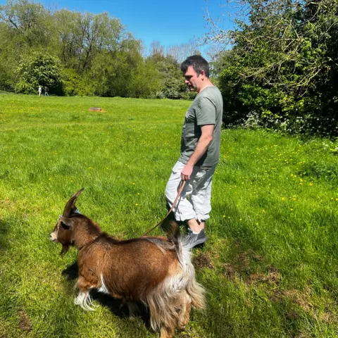 Lily-May Symonds/BBC Boo being walked in a park by David
