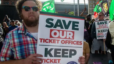 Getty Images Man protesting closure of ticket offices in England