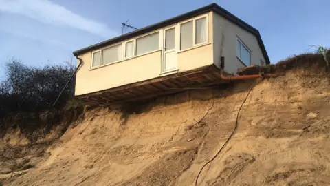 Hemsby house teetering over the sand dune