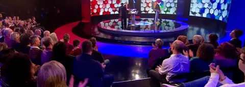 Audience members clapping