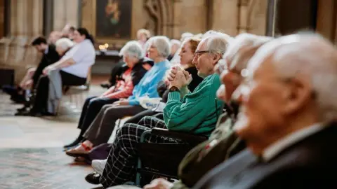 Alastair Brookes Care home residents sitting in the audience at Bristol Cathedral