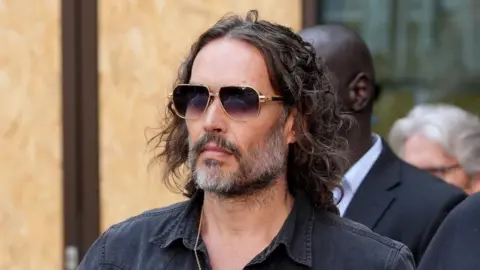 Russell Brand arrives outside court