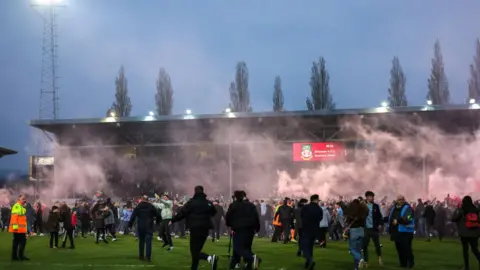 Getty Images Fans on pitch