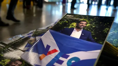 PA Media Picture of Humza Yousaf on a brochure at the SNP conference