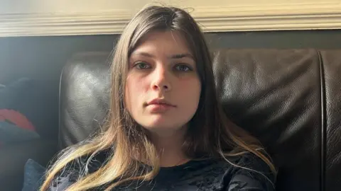 BBC Daisy Steinhardt sitting on a sofa looking at the camera