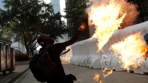 Reuters protester throws petrol bomb