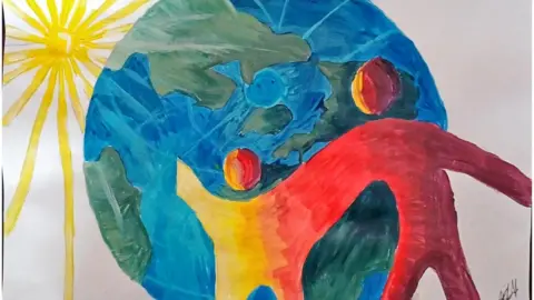 Julie Williams/Shaw Trust Two connected silhouettes stand in front of a globe