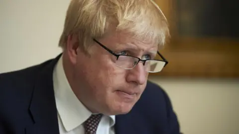 PA Media Boris Johnson has backed his close adviser throughout the scandal