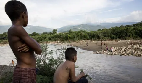 Glenna Gordon/Save the Children Children play in the river at the border of Columbia and Venezuela