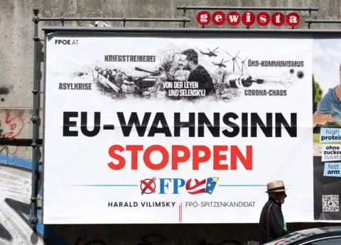 JOE KLAMAR/AFP People walk past a billboard with an election poster of Harald Vilimsky, the top candidate of the Austrian-conservative National Freedom Party and the right-wing FPO.