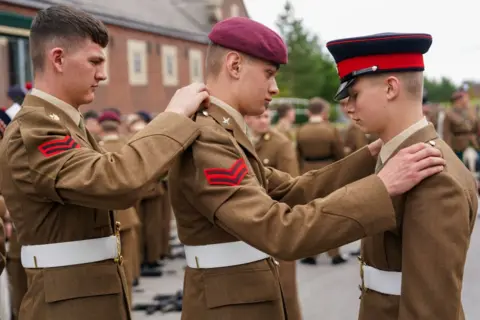  Ian Forsyth/Getty Images Junior soldiers prepare for their parade