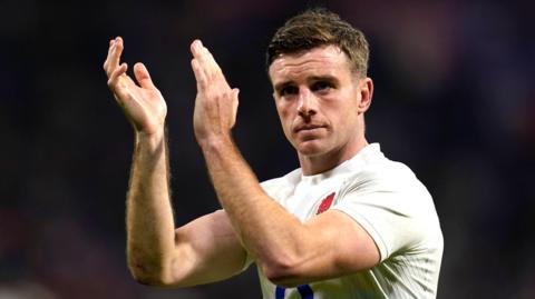 George Ford applauds fans while playing for England