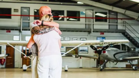 Elite Competitions A man and woman are seen hugging