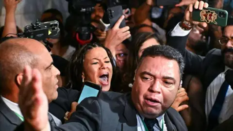 EPA A crowd of people involved in a scuffle in Brazil's parliament 