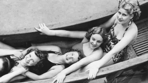 Getty Images Girls on the helter-skelter ride at Coney Beach Amusement Park in Porthcawl, Wales