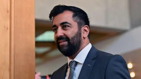 Getty Images Former First Minister Humza Yousaf on the way to the chamber of the Scottish Parliament for First Minister's Questions