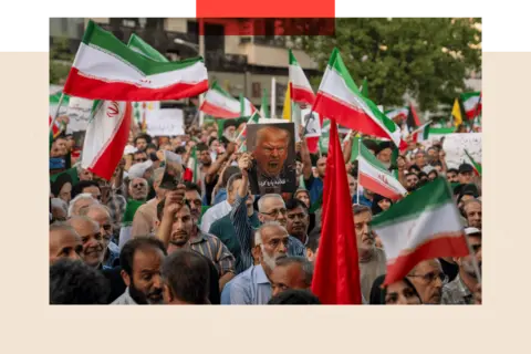 Getty Images Iranian protesters chant slogans and one holds a poster with a vampire-like illustration of Donald Trump in Revolution Square to protest US attacks on nuclear sites in Iran on 22 June 2025 in Tehran, Iran.
