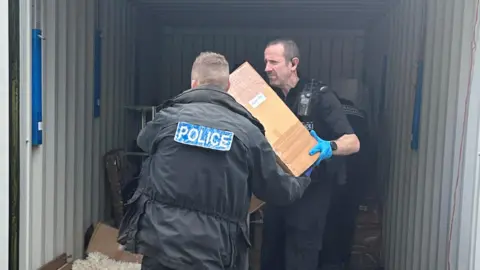 DEVON & CORNWALL POLICE Police retrieving boxes