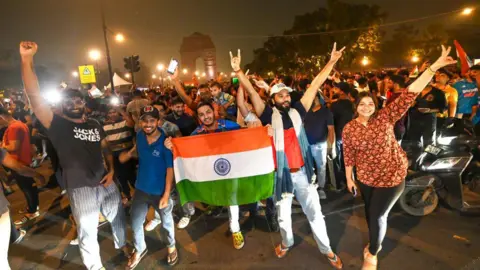  Fans celebrate near the India Gate after India won the T20 World Cup on June 30, 2024 in Delhi, India