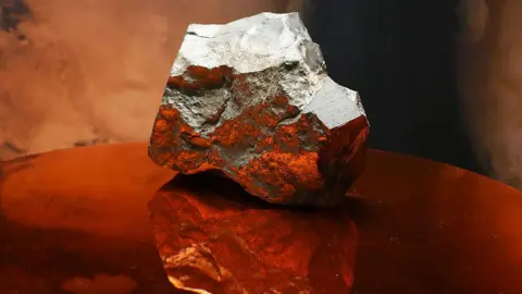 A grey-coloured Mars rock sits on podium