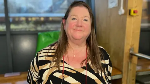 Kirsteen Middleton. She has long dark hair and is looking directly at the camera and smiling.