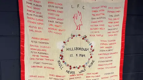 An embroidered banner with the names of all 97 victims of the 1989 Hillsborough disaster.