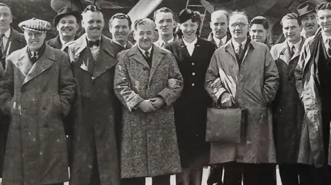 Supplied A close-up shot of part of the black and white photo which shows 13 men and the female air hostess. 