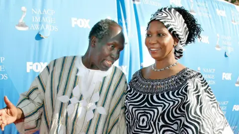 Getty Images Writer Ngugi wa Thiong'o (L) and his wife arrive at the 38th annual NAACP Image Awards held at the Shrine Auditorium