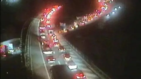 A CCTV image taken at night showing cars backed up on the M6 motorway