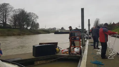 John Aston The barge after it has been secured at moorings. Four volunteers can been seen in the picture. 