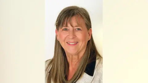 Mandy Chilcott Council website portrait of Mandy Chilcott. She has medium-length brown hair and a small stud in each each. She is smiling at the camera.