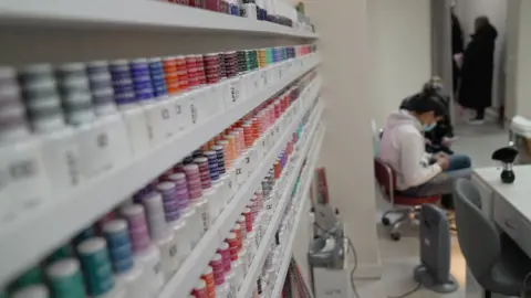 Rows of nail varnish products are seen in a shop 