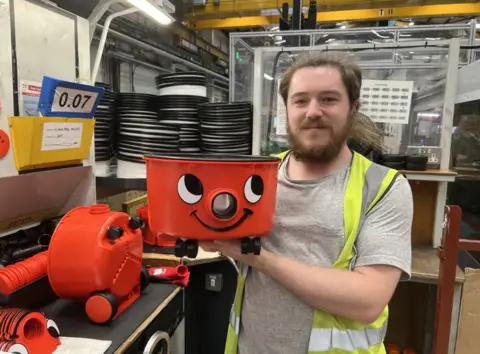 A man holding a Henry Hoover