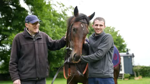 John Fairhall/BBC Trainer with horse and groom