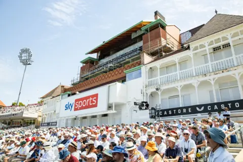 Eleri Tunstall A close-up image of the pavilion at Trent Bridge with rows of spectators sitting below it.
