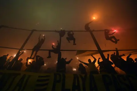 Dante Fernandez/AFP Peñarol fans cheer on their team before the start of the Copa Libertadores quarter-final between Uruguayan Peñarol and Brazil's Flamengo at the Campeon del Siglo stadium in Montevideo, on September 26, 2024. 