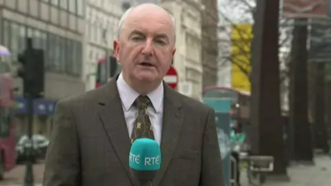 RTÉ Journalist with RTÉ microphone
