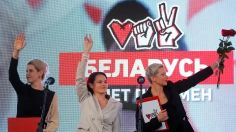 AFP Svetlana Tikhanovskaya (centre), Maria Kolesnikova, a representative of politician Viktor Babariko's campaign office (right), and Veronika Tsepkalo, wife of opposition figure Valery Tsepkalo, at a rally in Minsk, Belarus. Photo: 30 July 2020