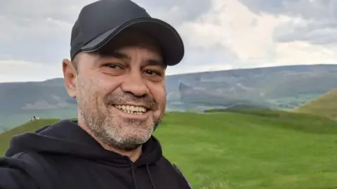 Police handout of Claudiu Carol-Kondor, a victim of either manslaughter and murder. He is wearing a black cap and smiling, in a selfie taken in the countryside.