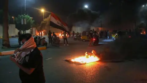 AFP Protesters set fire to the gates of the Iranian consulate's compound in Karbala on 9 May 2021