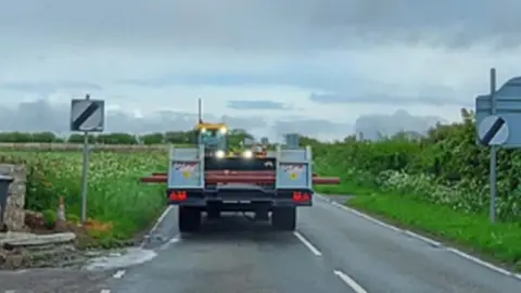 CPS the tractor driving down the road