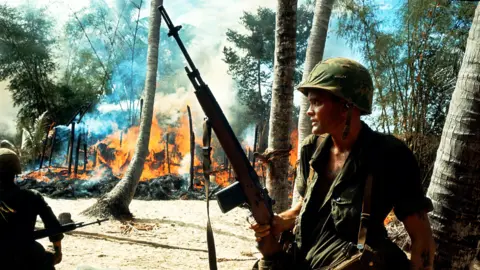 Getty Images US soldiers in a burning village during the Vietnam War, circa 1965