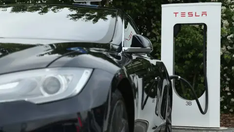 Getty Images Tesla next to refuelling plug