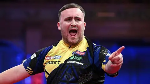 Luke Littler celebrates claiming a leg against Gerwyn Price in the World Matchplay final at Winter Gardens in Blackpool