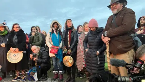 People celebrating winter solstice at Glastonbury Tor